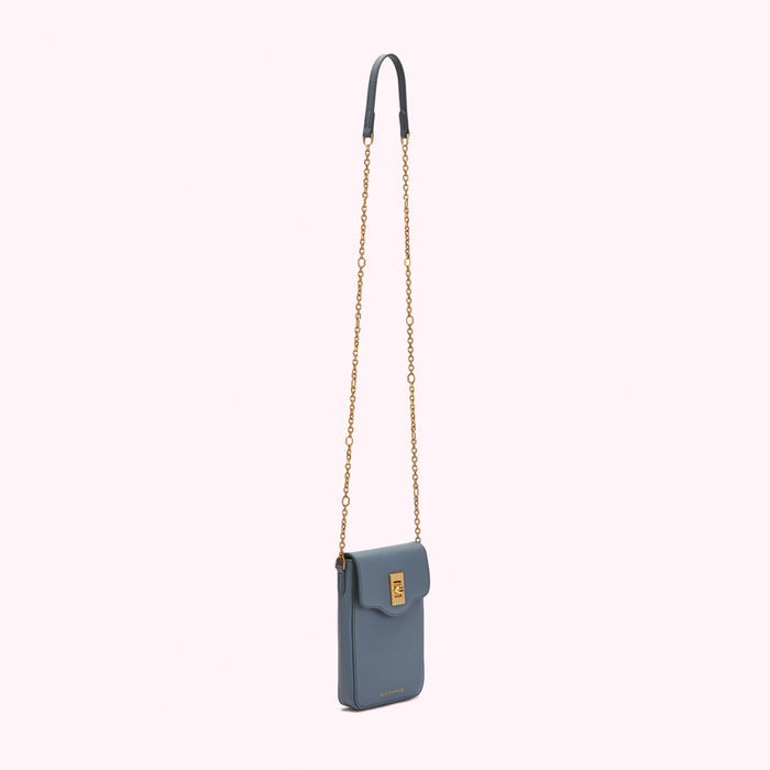 A dusty blue crossbody bag with a gold chain strap.