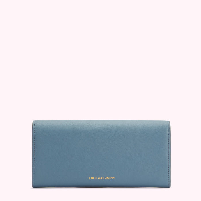 A powder blue Lulu Guinness wallet against a white background.