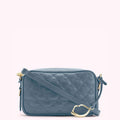 A dusty blue quilted crossbody bag with a gold clasp.