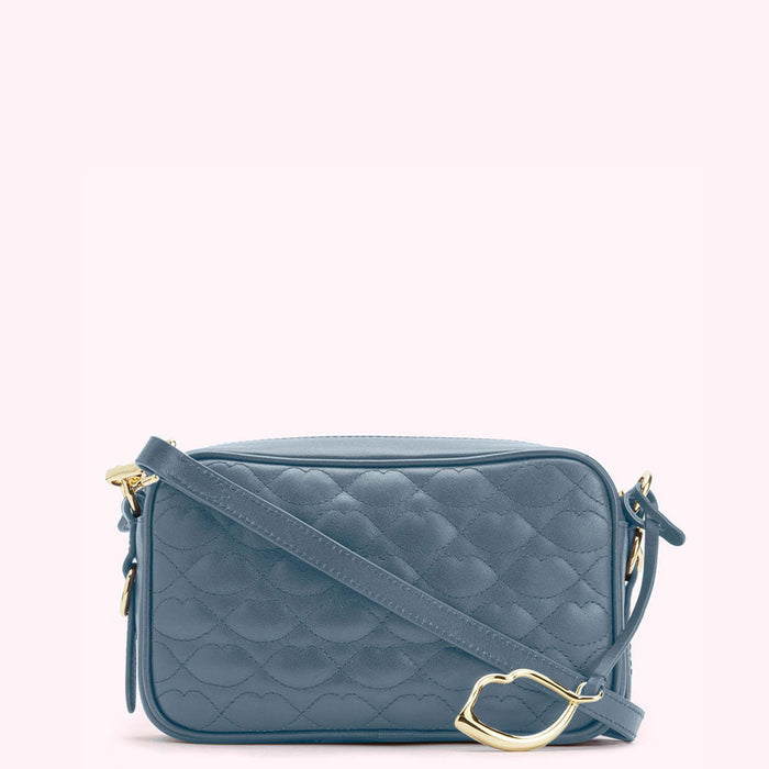 A dusty blue quilted crossbody bag with a gold clasp.