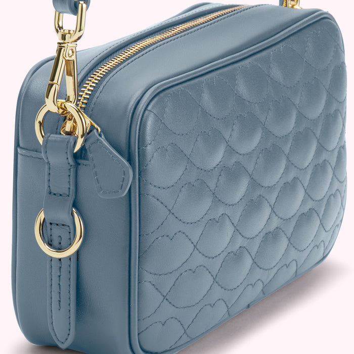 Dusty blue quilted crossbody bag with gold hardware.