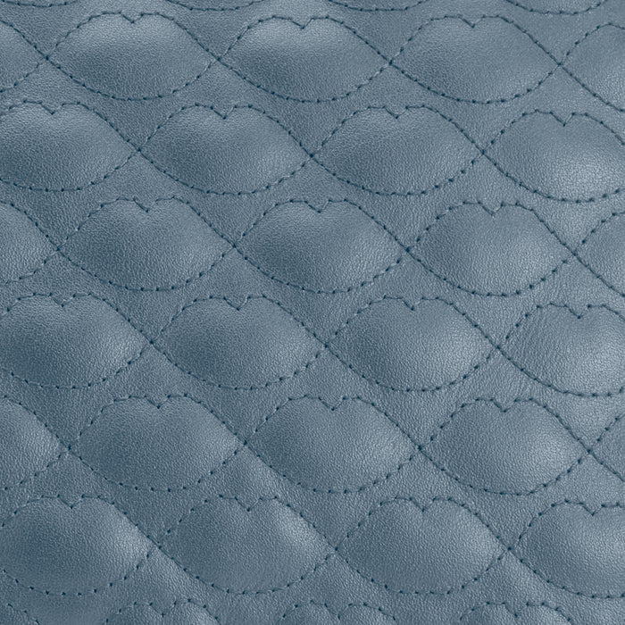 Close-up of blue quilted leather texture.