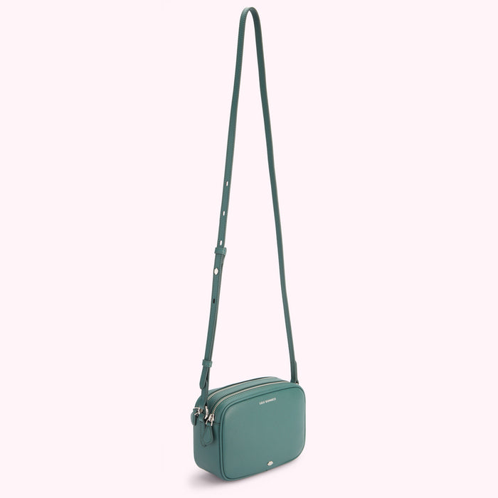 Teal crossbody bag with long strap.