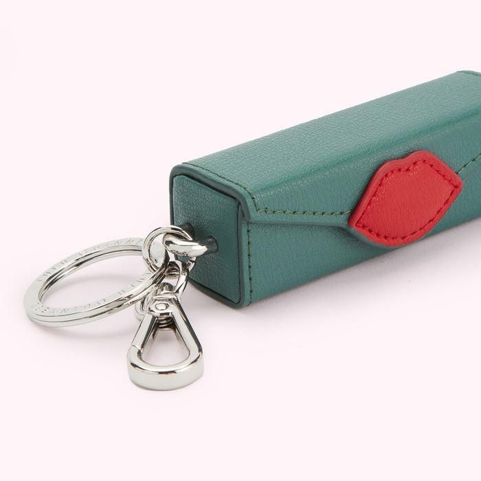 Teal leather lipstick-shaped keychain with a red lip detail and silver keyring.