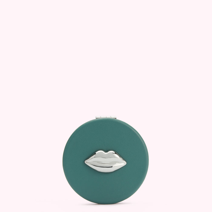 Teal round compact mirror with silver lip design.
