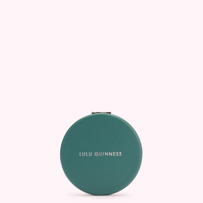 Teal round compact mirror with Lulu Guinness logo.
