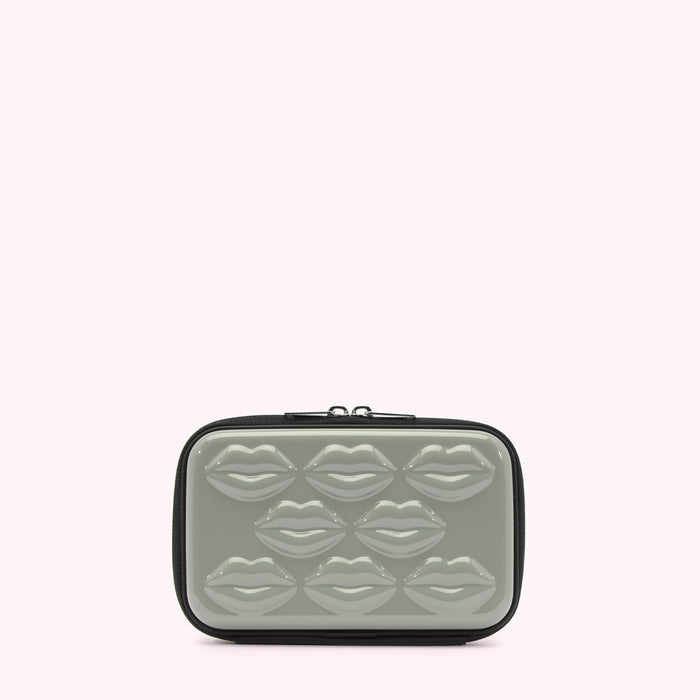 Sage green cosmetic bag with black trim and lip-shaped embellishments.