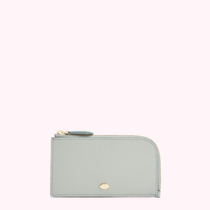 Light blue leather zip-around card holder with gold zipper and logo.