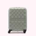 Sage green Lulu Guinness suitcase covered in a pattern of embossed lips.