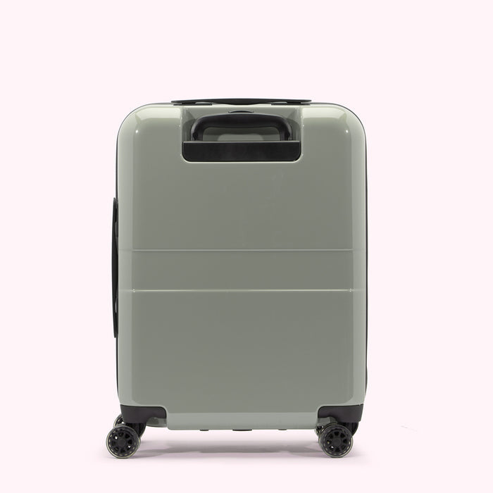 Sage green carry-on suitcase with black wheels and handle, shown from the back.