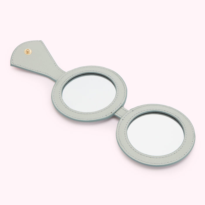 Pale-blue double-sided handheld compact mirror.