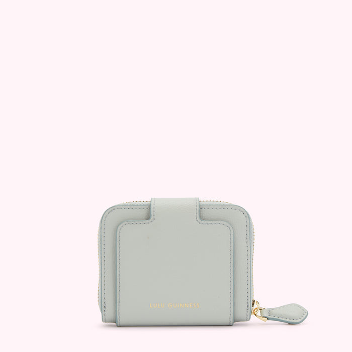 Light blue Lulu Guinness zip-around wallet against a white background.