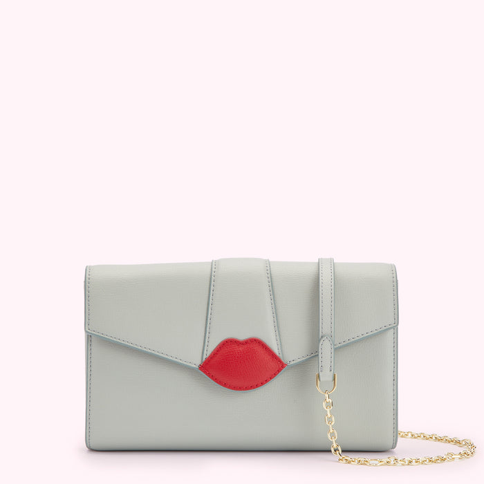 Light grey leather clutch with red lip detail and gold chain strap.
