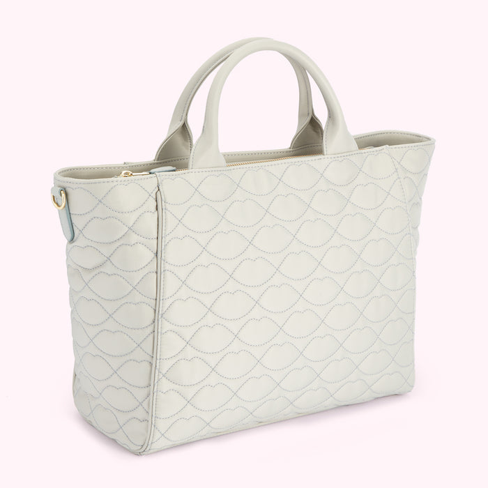 Light grey quilted tote bag with lip-shaped pattern.