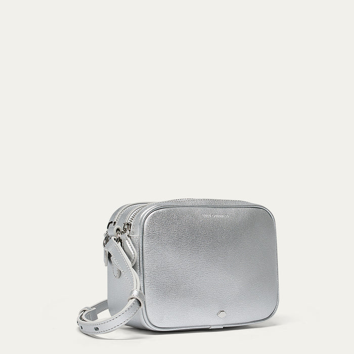 Silver crossbody bag on a light gray background