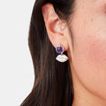 Silver lip-shaped earrings with purple amethyst stones.