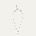Silver necklace with a lip shaped pendant with a crystal design on a light gray background