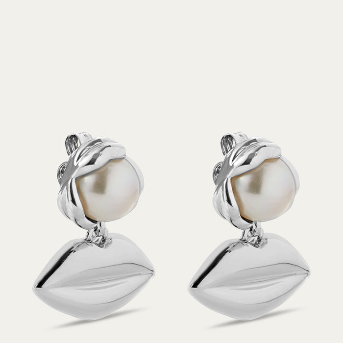 Pair of silver lip pendant drop earrings with pearls on a white background