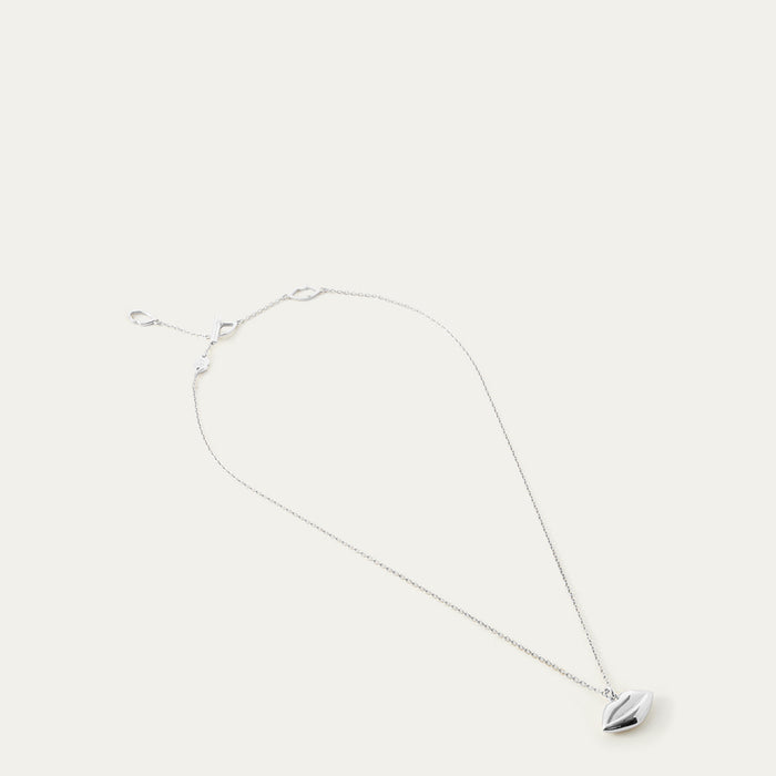 Silver necklace with a lip-shaped pendant on a white background
