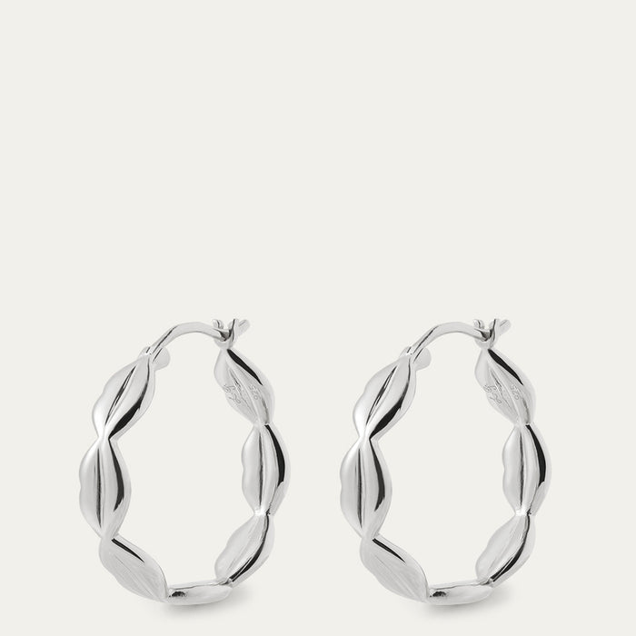 Silver hoop earrings on a light gray background