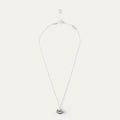 Silver and ruby necklace with a lip-shaped pendant on a white background