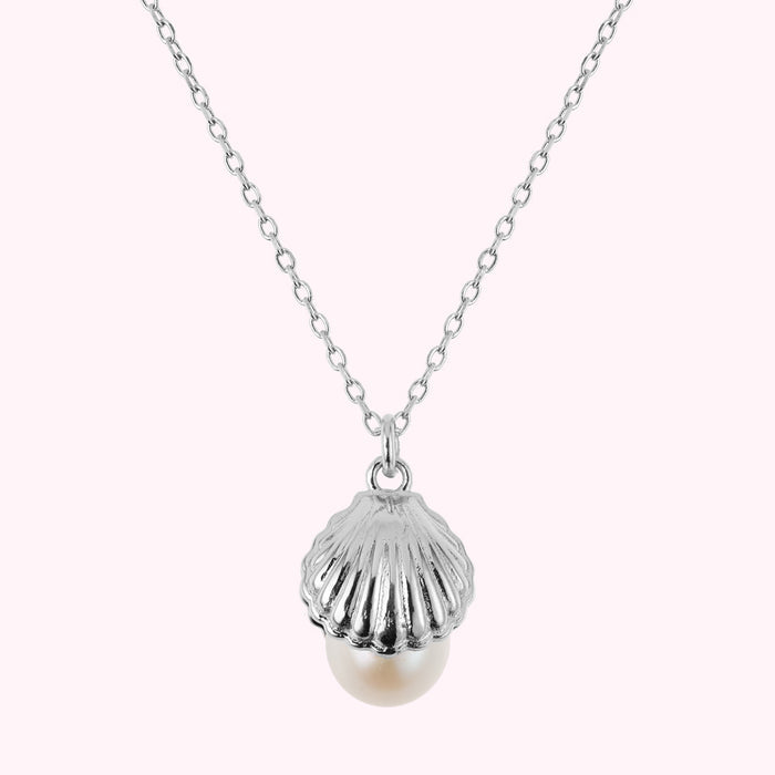 Close up image of a sterling silver shell pendant with a freshwater pearl.