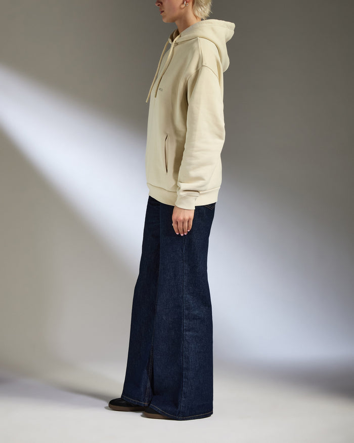 a woman in a hoodie and jeans