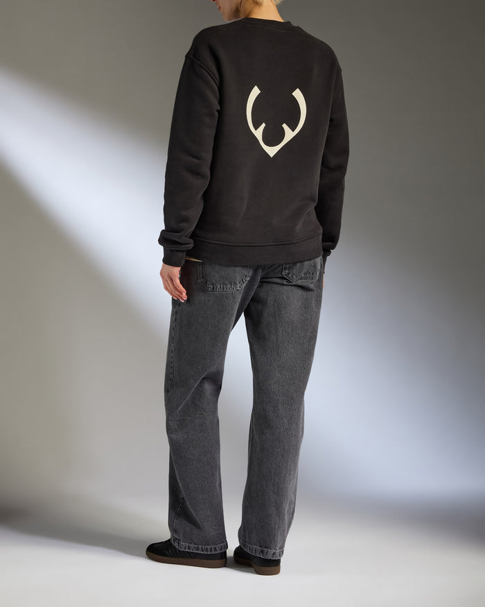 a person standing in a black sweatshirt