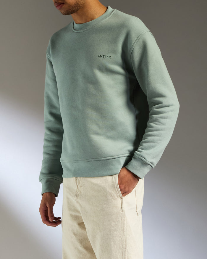 a man in a green sweatshirt