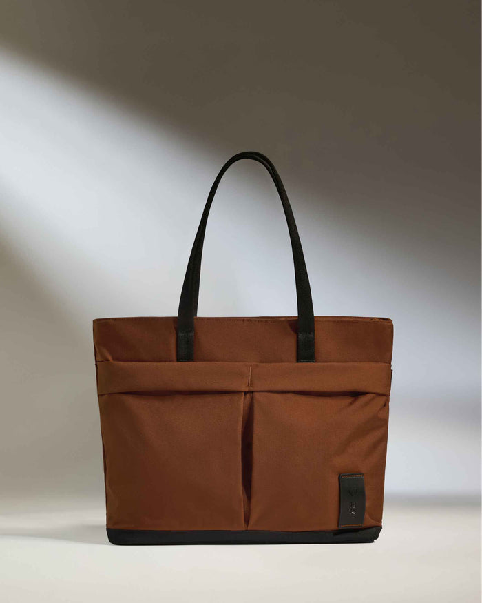 a brown bag with black handles