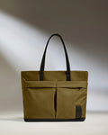a green bag with black handles
