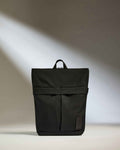 a black backpack with a strap