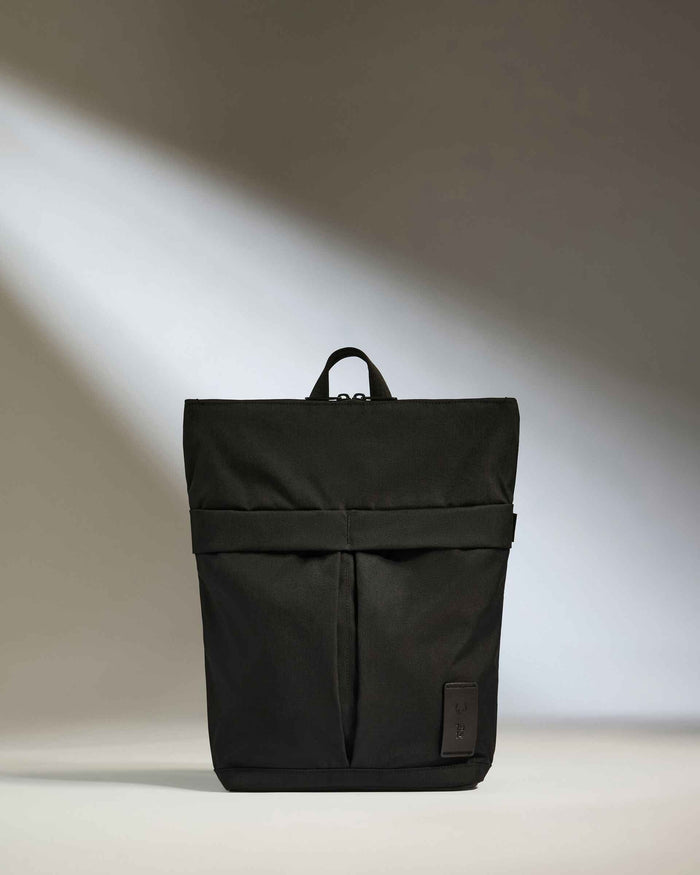 a black backpack with a strap