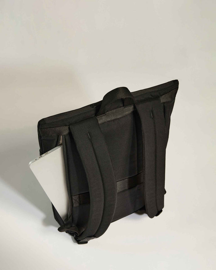 a black bag with a white card in it