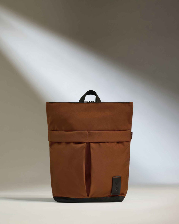 a brown bag with a black strap