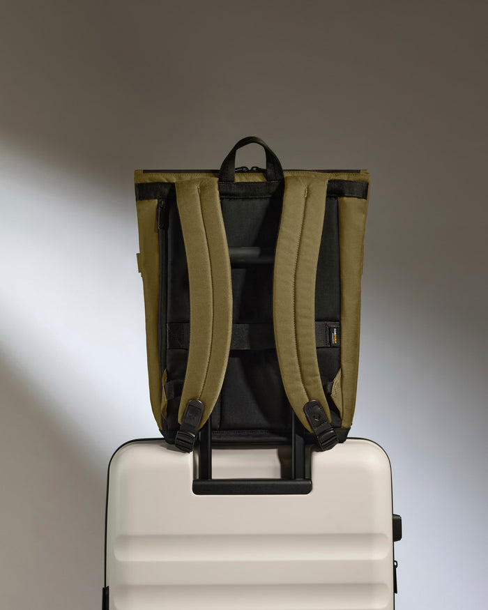 a backpack on top of a suitcase