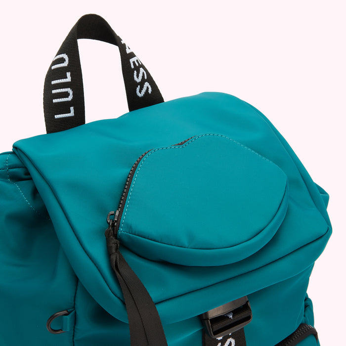 Close-up of a teal Lulu Guinness backpack with a lip-shaped zipper pocket.