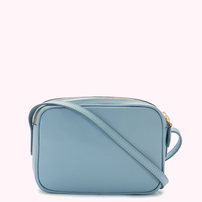 A light blue leather crossbody bag with a gold zipper.
