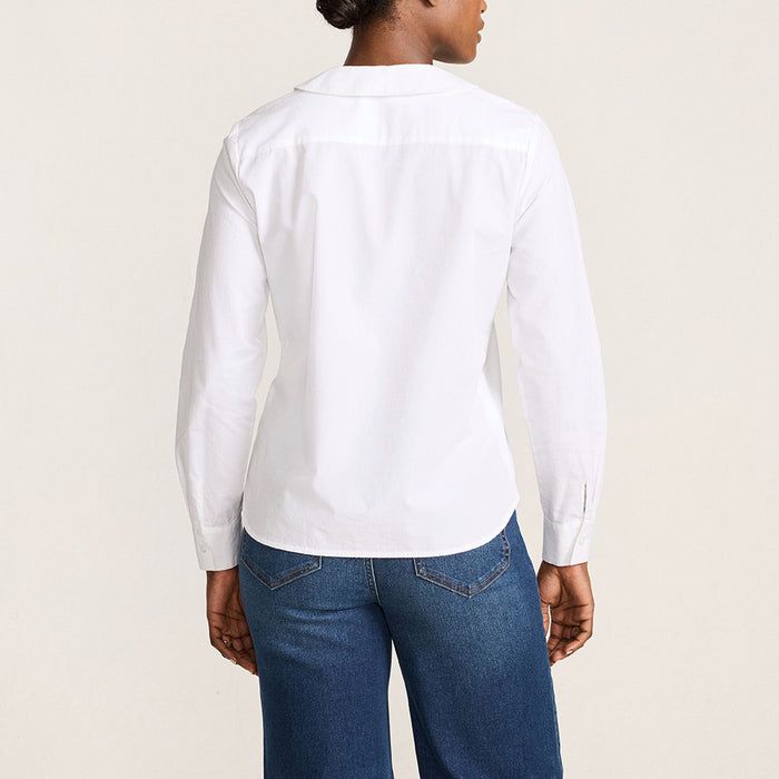 Women wearing a white cotton shirt against a beige background