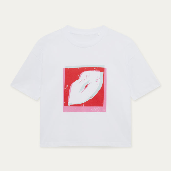 White t-shirt with a red and white pop art lip graphic on a light gray background