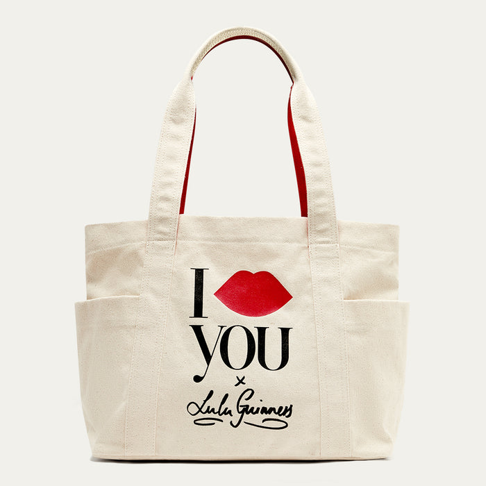Beige tote bag with 'I Lip YOU x Lulu Guinness' and red lips design on a white background